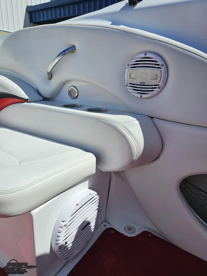 Slide: The Image of 2002 Baja 342 boat interior with white seating and built-in speakers. - 49