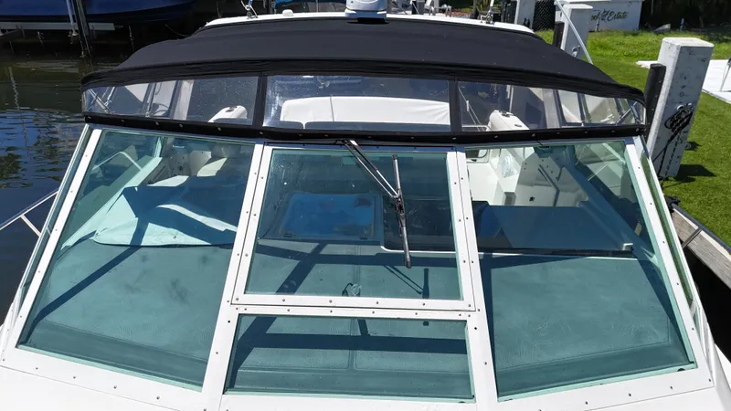 Slide: The Image of 1998 Tiara Yachts 3500 Express boat with black canopy and clear windshield. - 10