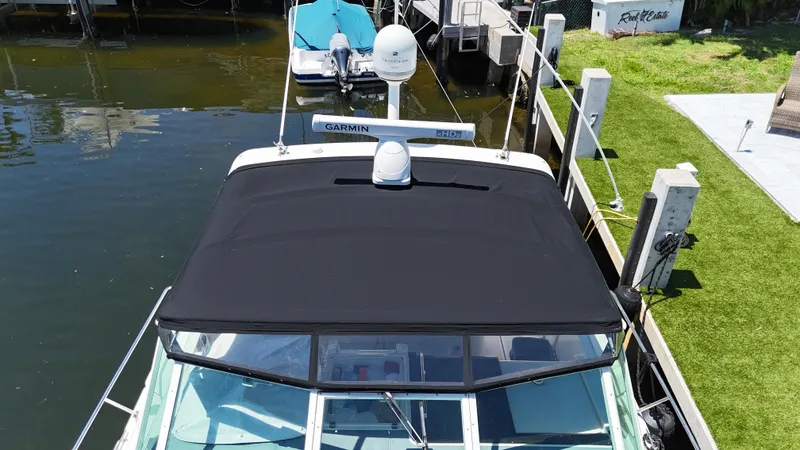 Slide: The Image of 1998 Tiara Yachts 3500 Express docked, featuring black canopy and Garmin equipment. - 11