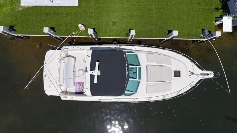 Slide: The Image of Overhead view of a 1998 Tiara Yachts 3500 Express docked by green grass. - 12