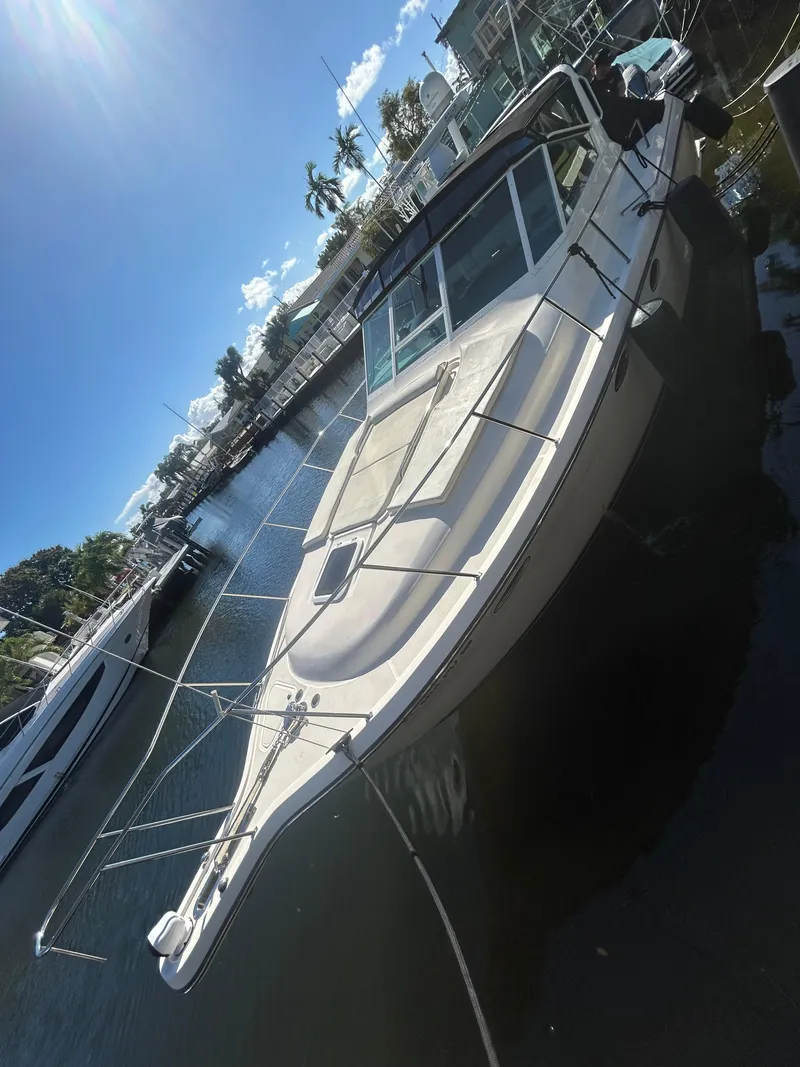 Slide: The Image of 1998 Tiara Yachts 3500 Express docked under a clear blue sky. - 16