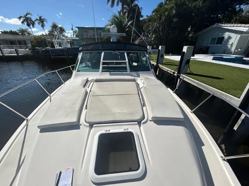 Slide: The Image of 1998 Tiara Yachts 3500 Express docked, showcasing spacious deck and sleek design. - 23