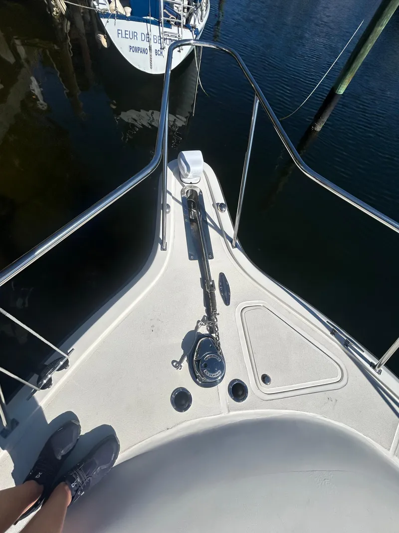 Slide: The Image of Bow of 1998 Tiara Yachts 3500 Express, docked, with visible anchor and railing. - 26