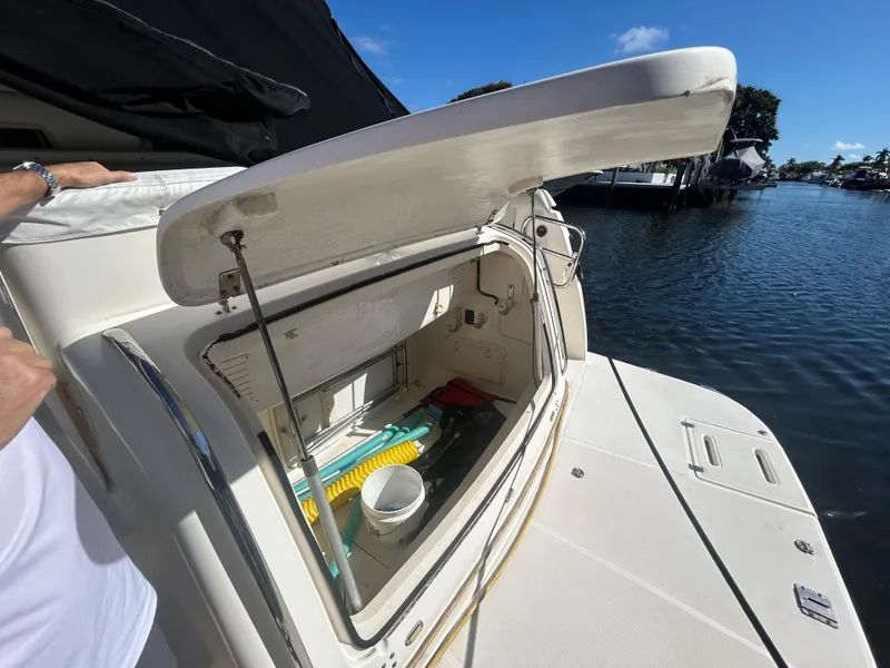 Slide: The Image of Open storage compartment on a 1998 Tiara Yachts 3500 Express by the water. - 28