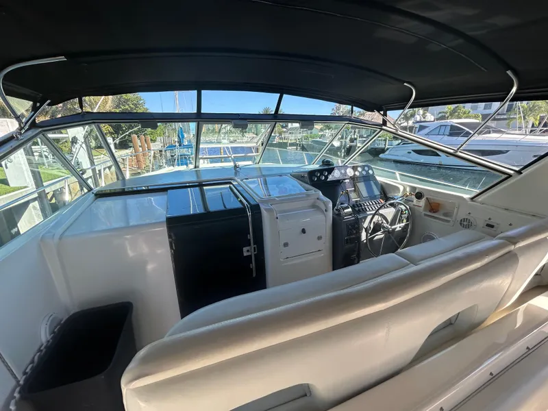 Slide: The Image of 1998 Tiara Yachts 3500 Express cockpit with helm, seating, and navigation equipment. - 29