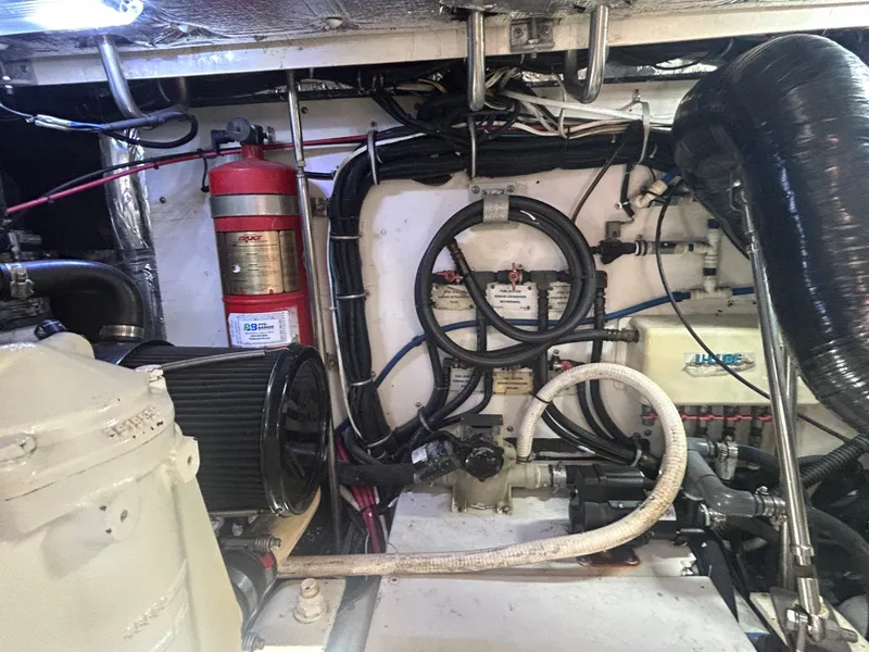 Slide: The Image of Engine room of a 1998 Tiara Yachts 3500 Express, showcasing mechanical components and wiring. - 31