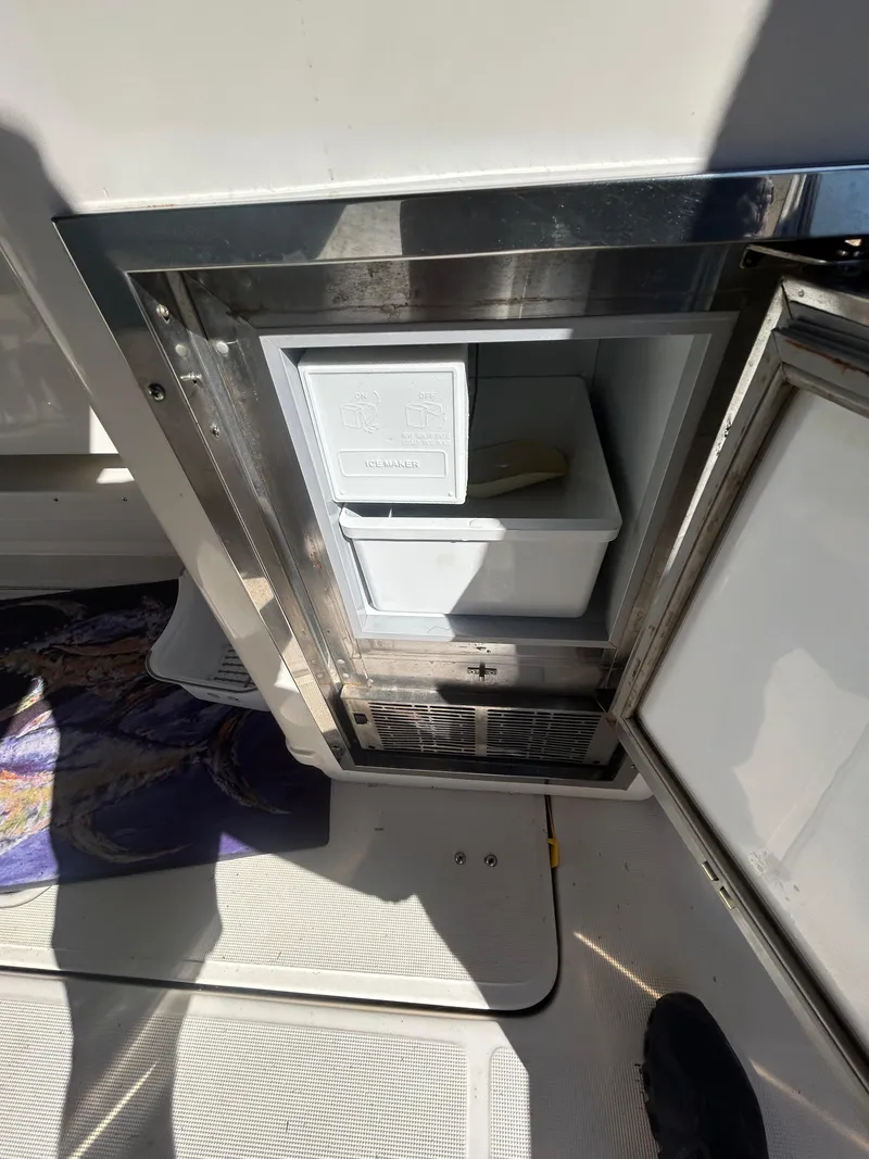 Slide: The Image of 1998 Tiara Yachts 3500 Express, open mini fridge on deck, stainless steel finish. - 42