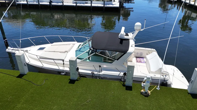 Slide: The Image of 1998 Tiara Yachts 3500 Express docked on calm water. - 8