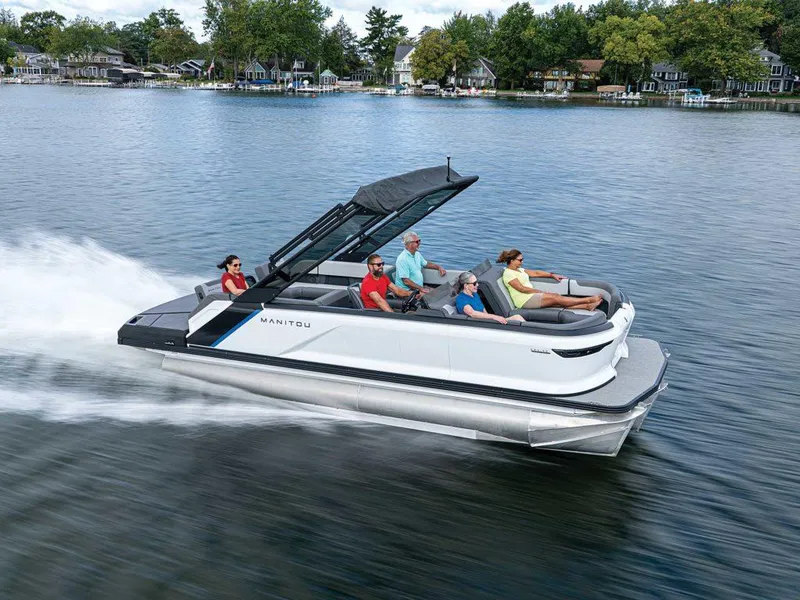 The Image of 2025 Manitou 22 Explore MAX Deck Navigator cruising on a lake with passengers. - 0