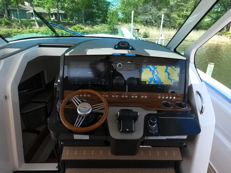 Slide: The Image of 2024 Tiara Yachts 43 LS helm with advanced navigation system and wooden steering wheel. - 15