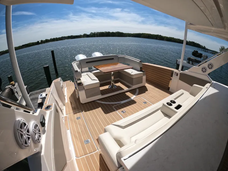 Slide: The Image of 2024 Tiara Yachts 43 LS luxury deck with seating, overlooking serene water. - 5