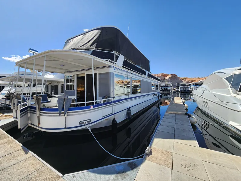 The Image of 2004 Skipperliner Inn Conspicuous Share houseboat docked under clear blue sky. - 1