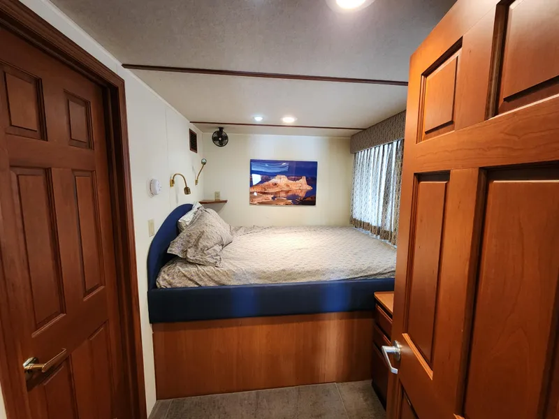 Slide: The Image of Cozy bedroom in 2004 Skipperliner Inn Conspicuous Share with wooden accents and wall art. - 10