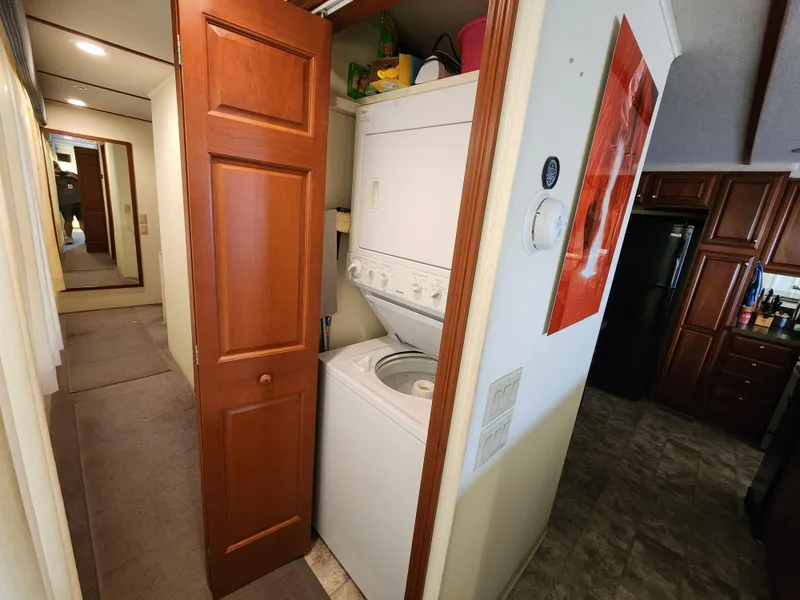 Slide: The Image of Laundry area with stacked washer and dryer in a 2004 Skipperliner Inn Conspicuous Share. - 12
