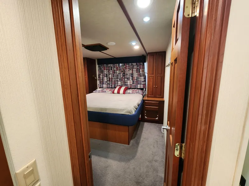 Slide: The Image of Cozy bedroom in 2004 Skipperliner Inn Conspicuous Share with wood accents and patterned curtains. - 16