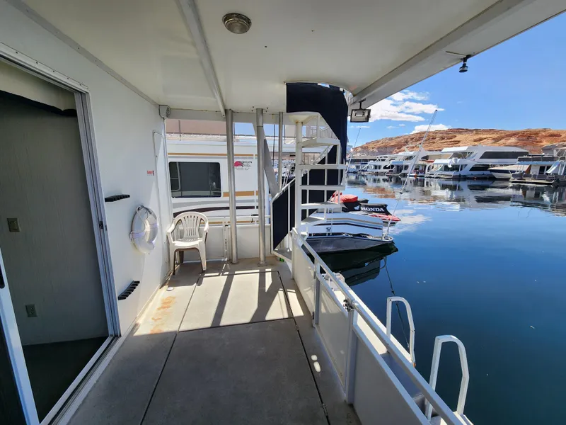 Slide: The Image of 2004 Skipperliner Inn Conspicuous Share houseboat docked at marina with scenic water view. - 19