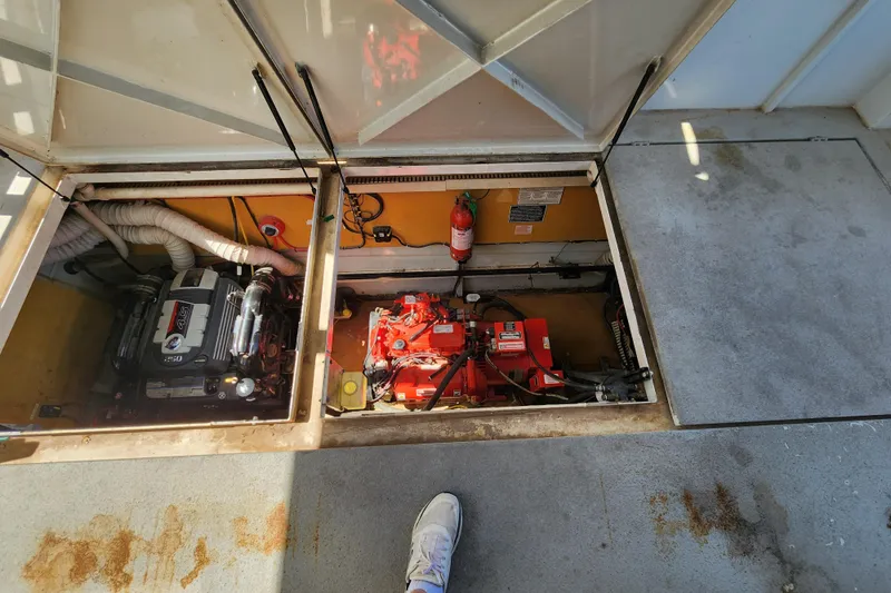 Slide: The Image of 2004 Skipperliner Inn Conspicuous Share engine compartment with visible machinery and fire extinguisher. - 21