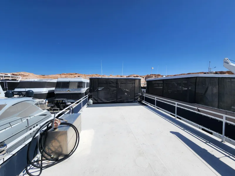 Slide: The Image of 2004 Skipperliner Inn Conspicuous Share boat deck under clear blue sky. - 23