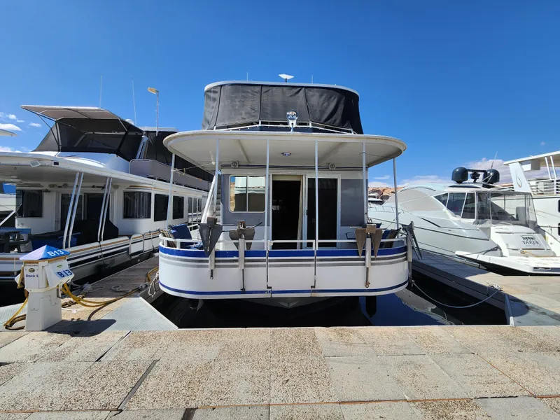 Slide: The Image of 2004 Skipperliner Inn Conspicuous Share houseboat docked under clear blue sky. - 3