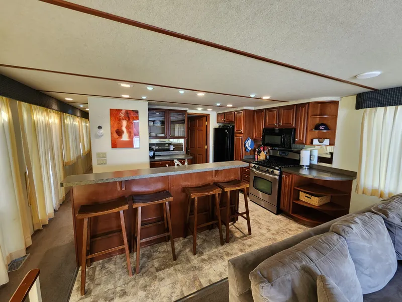 Slide: The Image of Luxurious 2004 Skipperliner houseboat interior with modern kitchen and cozy seating area. - 8