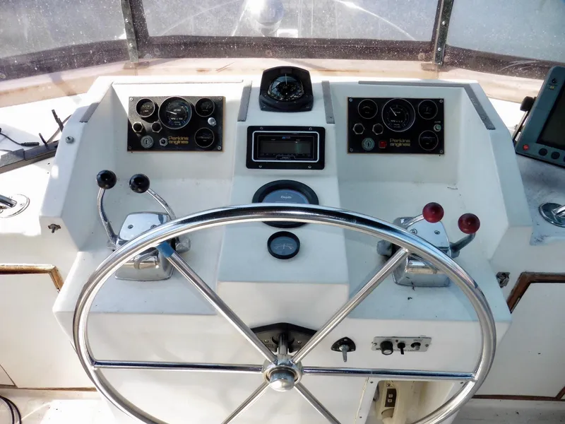 Slide: The Image of Helm of 1984 Ponderosa 42 boat with steering wheel and control panels. - 13