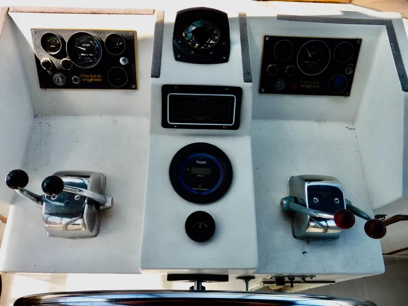 Slide: The Image of Control panel of a 1984 Ponderosa 42 boat with gauges and levers. - 16