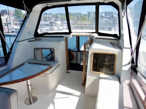 Slide: The Image of Interior of 1984 Ponderosa 42 boat with seating and table, docked at marina. - 19