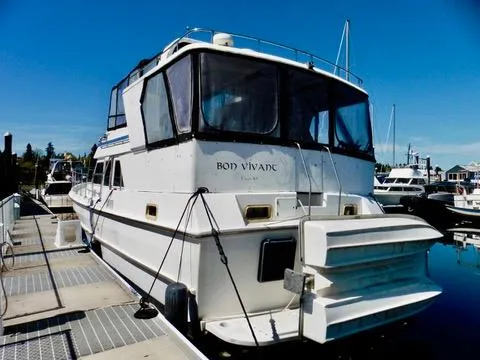 Slide: The Image of 1984 Ponderosa 42 yacht docked at marina under clear blue sky. - 2