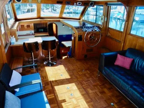 Slide: The Image of Interior of 1984 Ponderosa 42 yacht with wood paneling, seating, and helm station. - 21