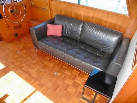 Slide: The Image of Luxurious leather sofa in 1984 Ponderosa 42 yacht interior with wooden flooring. - 22