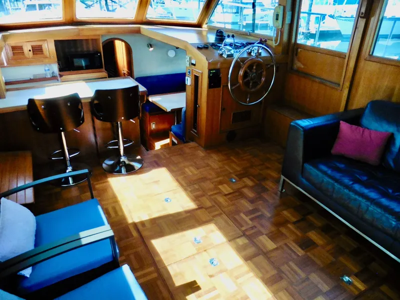 Slide: The Image of Luxurious interior of 1984 Ponderosa 42 yacht with wood flooring and modern seating. - 26