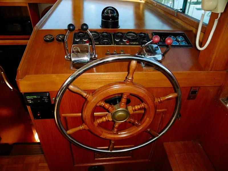 Slide: The Image of Wooden helm of a 1984 Ponderosa 42 boat with control levers and gauges. - 27