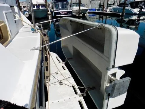Slide: The Image of 1984 Ponderosa 42 boat with dinghy lift system at marina. - 3