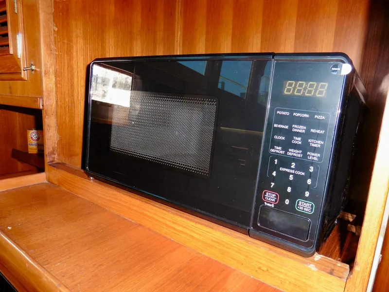 Slide: The Image of Vintage 1984 Ponderosa 42 microwave on wooden shelf, digital display, and control panel. - 37