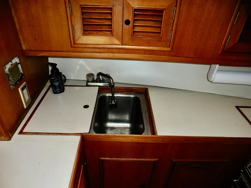 Slide: The Image of 1984 Ponderosa 42 yacht kitchen with wooden cabinets and stainless steel sink. - 39