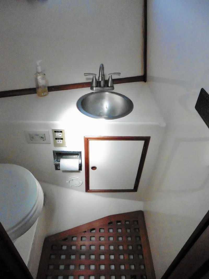 Slide: The Image of 1984 Ponderosa 42 yacht bathroom with sink, toilet, and wooden floor. - 47