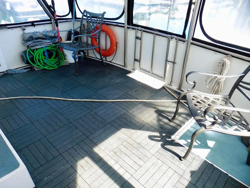 Slide: The Image of Spacious deck of 1984 Ponderosa 42 boat with chairs and nautical equipment. - 8