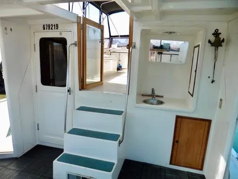 Slide: The Image of 1984 Ponderosa 42 boat interior with stairs, sink, and wooden cabinet. - 9