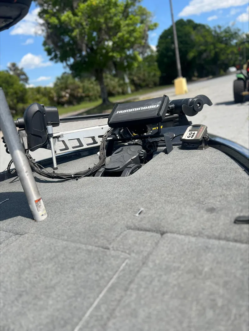 Slide: The Image of 2019 Skeeter ZX225 boat deck with electronics, set against a sunny outdoor backdrop. - 11