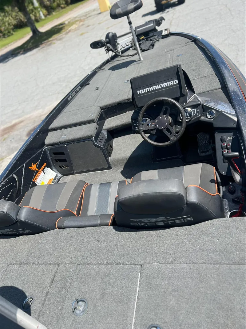 Slide: The Image of 2019 Skeeter ZX225 boat interior with Humminbird electronics and dual seating. - 13