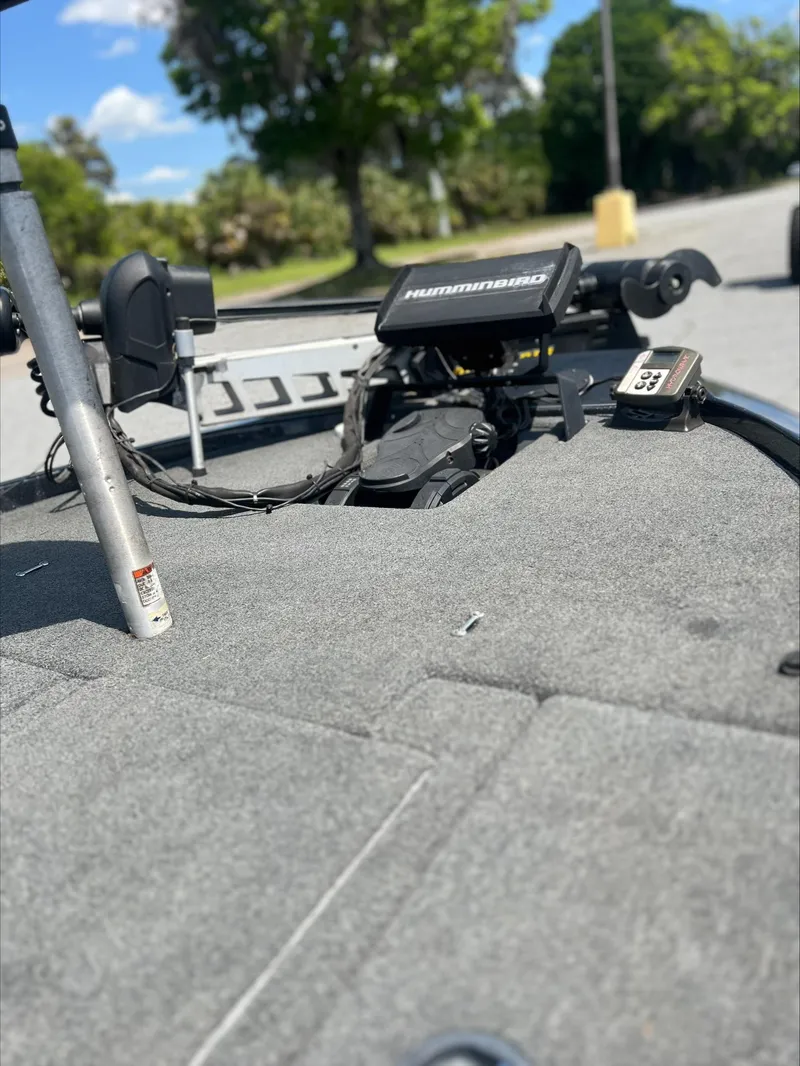 Slide: The Image of 2019 Skeeter ZX225 boat deck with Humminbird electronics, parked outdoors. - 3