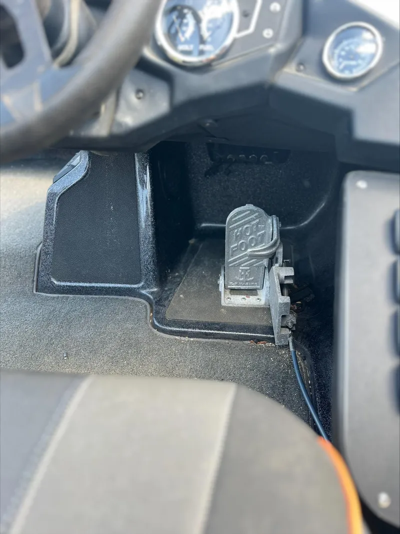 Slide: The Image of 2019 Skeeter ZX225 boat interior with foot pedal and dashboard controls. - 4