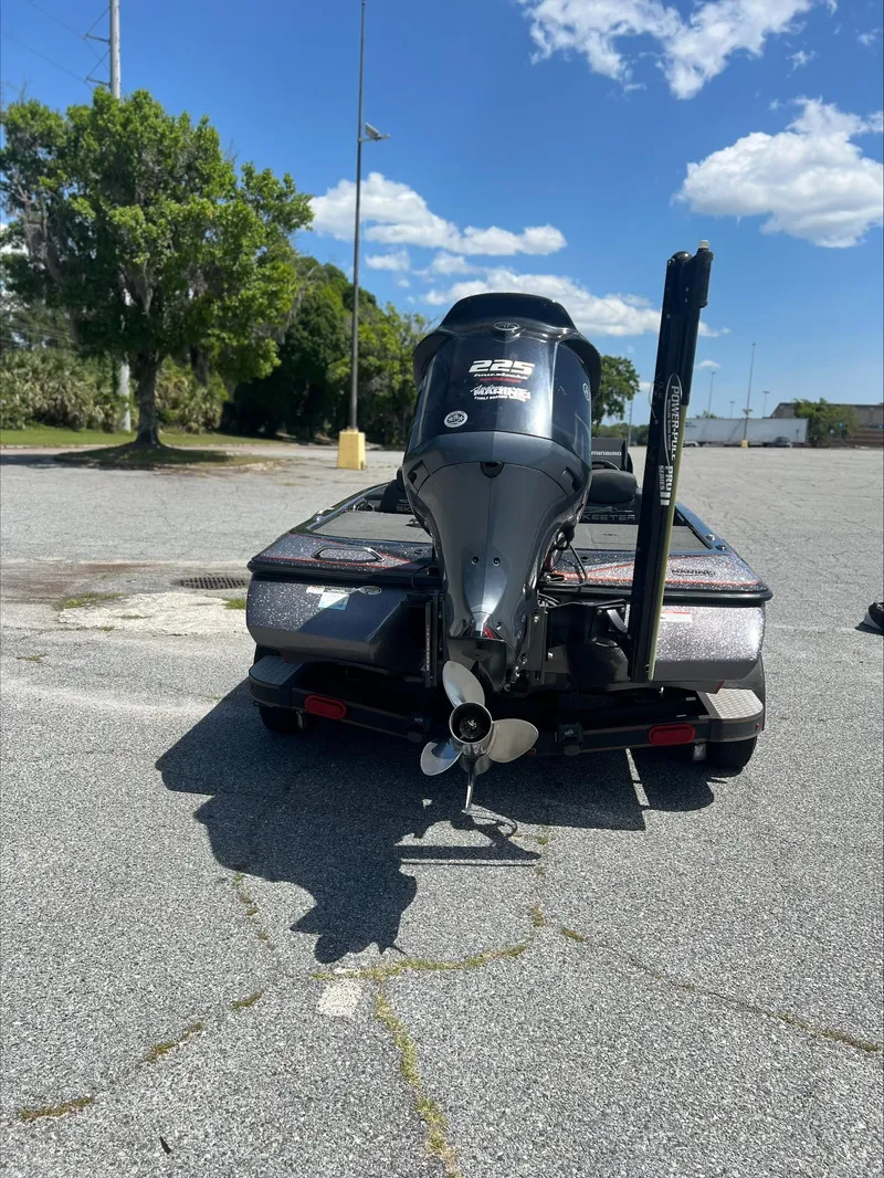 Slide: The Image of 2019 Skeeter ZX225 boat with powerful outboard motor in a sunny parking lot. - 6
