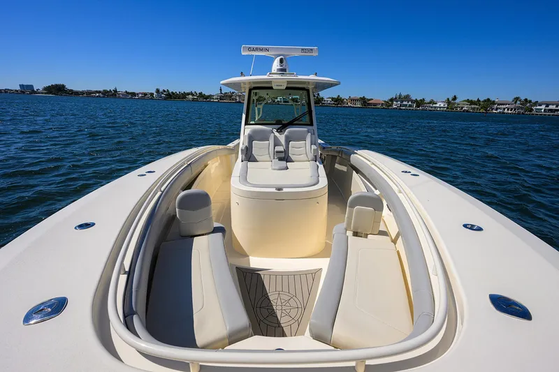 Slide: The Image of 2023 Scout 355 LXF boat on water, showcasing sleek design and spacious seating. - 19