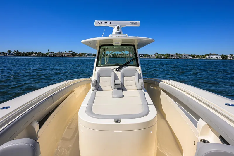 Slide: The Image of 2023 Scout 355 LXF boat on water, featuring sleek design and spacious seating. - 21