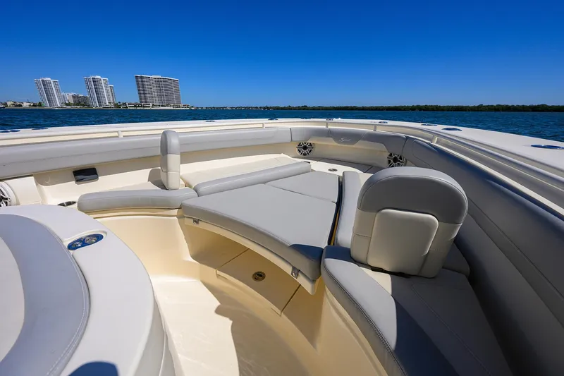 Slide: The Image of 2023 Scout 355 LXF boat interior with luxurious seating and ocean view. - 24