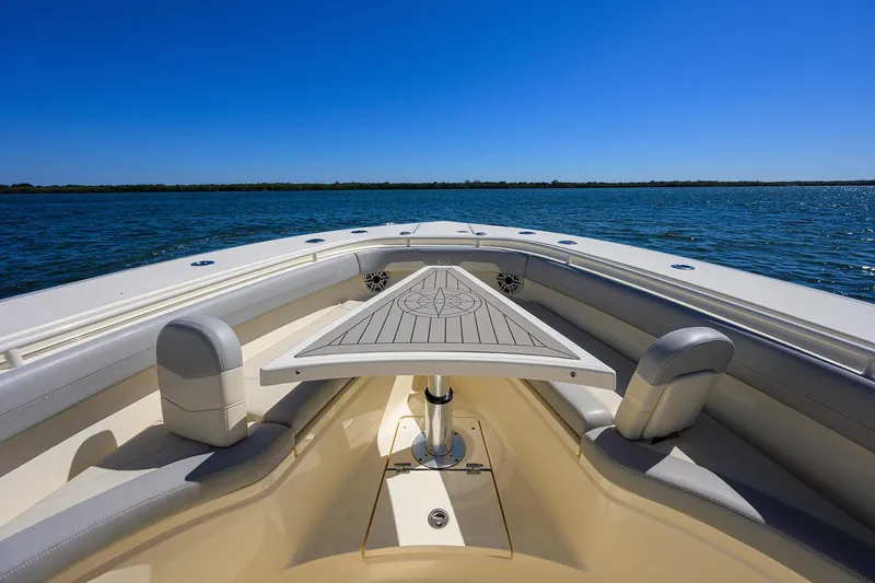 Slide: The Image of 2023 Scout 355 LXF boat with sleek deck design on open water. - 27