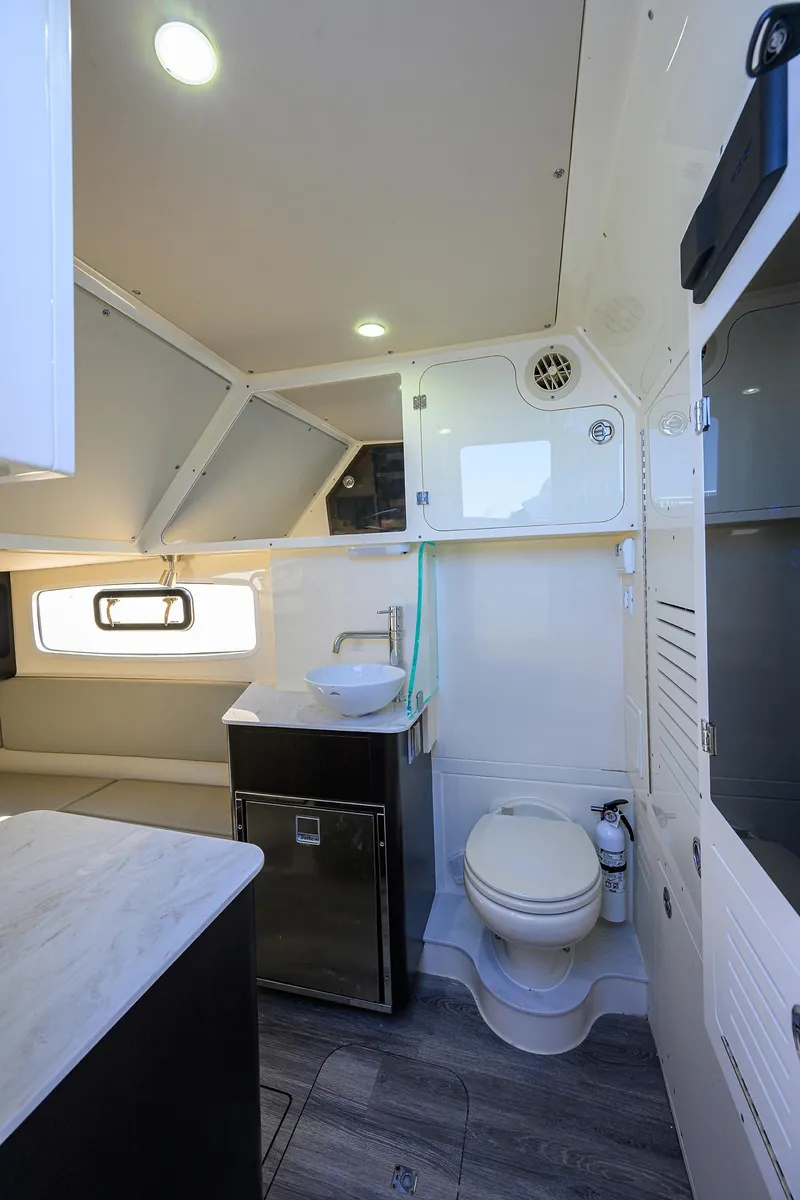 Slide: The Image of 2023 Scout 355 LXF boat interior with modern bathroom amenities. - 30