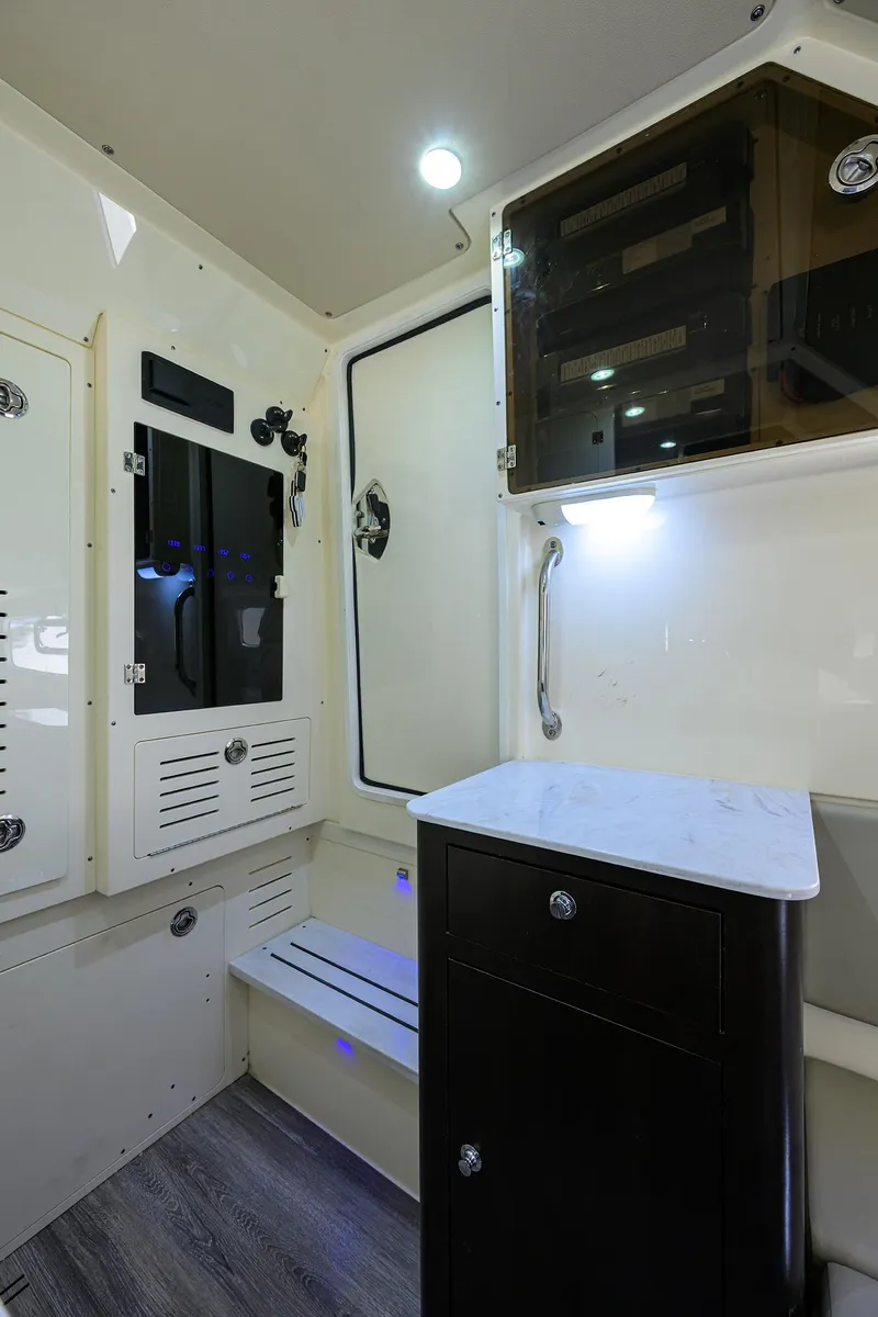 Slide: The Image of 2023 Scout 355 LXF interior with modern cabinetry and sleek design. - 35