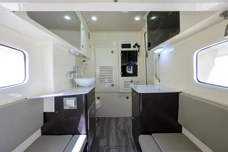 Slide: The Image of 2023 Scout 355 LXF interior with modern seating, sink, and storage. - 41